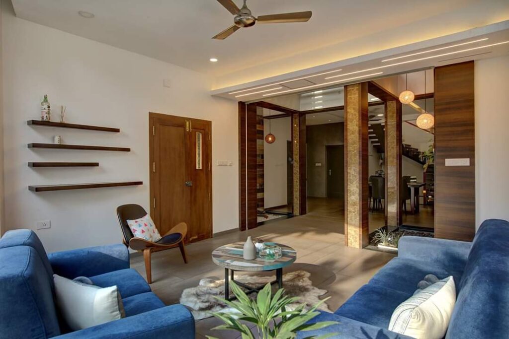 beautifully crafted living area with blue color sofa set and breathtaking interior design