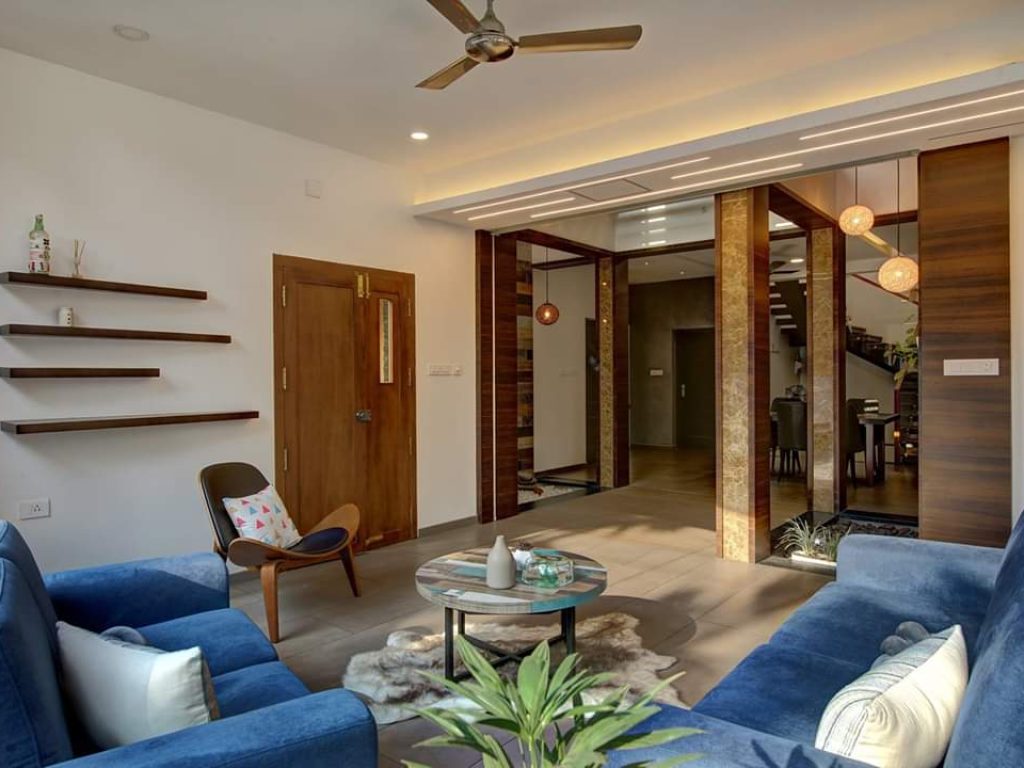 Blue Sofa and recreational area interior designed by space and luxe